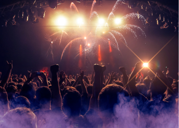 Audience hands raised at music venue